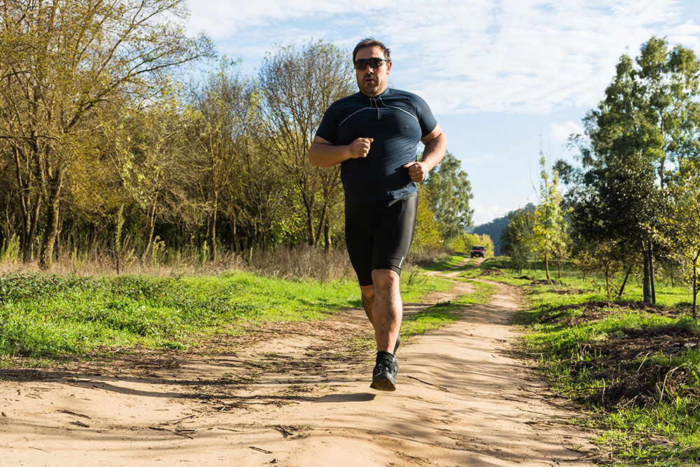 man jogging on a hike trail